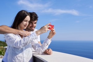 happy young couple taking selfie with cell phone